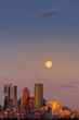 A winter full moon at sunrise sets over the city of Calgary Alberta. Copy space