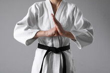 Martial Arts Master In Keikogi With Black Belt On Grey Background, Closeup