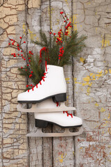 Poster - Pair of ice skates with Christmas decor hanging on old wooden door