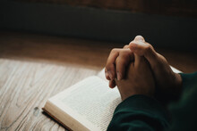 Man Hands Clasped Together On Holy Bible In Church Concept For Faith, Spirituality, And Religion, Man Hand With Bible Praying. World Day Of Prayer, International Day Of Prayer, Hope, Thankful.
