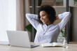 © fizkes - Relaxed happy young african american business woman employee worker enjoying carefree break time after hard working day in modern office, resting finishing online project or meeting deadline.