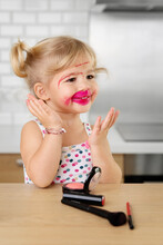 Portrait Of Proud Young Girl With Lipstick All Over Her Face