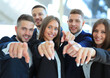 © ty - Portrait of excited young business people pointing at you