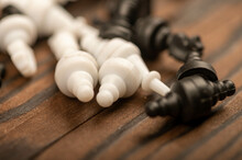 Black And White Chess Pieces Scattered On A Wooden Table, Close-up, Selective Focus.