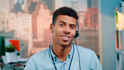 Wall Mural - Close-up shot of mixed-race customer service operator talking to client in call center with skyscrapers in the background.