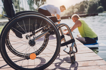 Wall Mural - Person with a physical disability who uses wheelchair will be ride on sup board