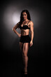 © vadim_fl - Athletic body of young woman over dark background. Fitness concept.