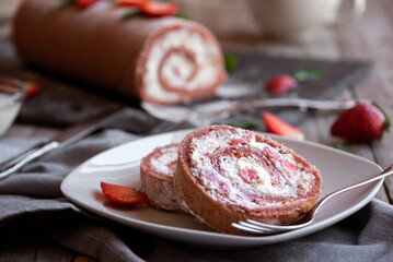 Delicious strawberry roll cake with white cream, homemade baked dessert