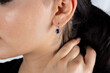 Jewelry, earrings in a beautiful girl's ear, women's accessories, gold earrings, earrings with stones, special diamonds