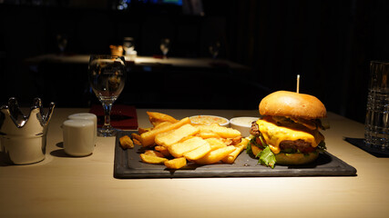 Poster - Burger served as dinner in a dark-lid restaurant in Berlin, Germany.