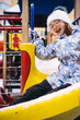 © Анна Молько - child playing in the playground. happy children on a slide. winter coat and white hat