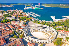 Arena Pula. Ancient Ruins Of Roman Amphitheatre And Pula Waterfront Aerial View