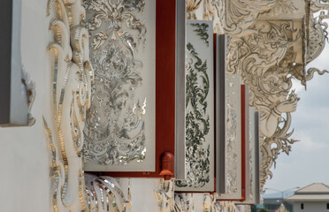 Wall Mural - Chiang Rai, Thailand - Sep 05, 2020 : Elaborate sculptures of windows at the famous Wat Rong Khun (White Temple) in Chiang Rai, Thailand. Selective Focus.