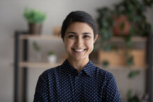 Happy Young Millennial Indian Business Woman Head Shot Portrait. Female Professional, Leader, Entrepreneur Profile Picture. Smiling Confident Ethnic Employee Looking At Camera. Video Call Screen