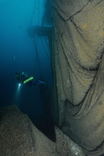 Scuba Diver Explores Sunken Shipwreck With Fishing Net, Catalina Island, California, USA