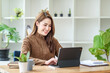 © amnaj - Pretty young Asian female student studying online on laptop computer.
