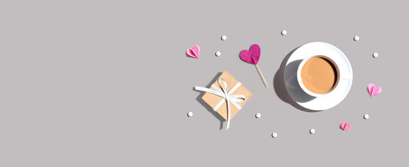 Poster - A cup of coffee with a gift box and hearts - flat lay