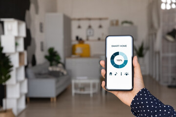 Smart home infographic graph on smartphone screen close up. Woman holding mobile phone, using app for electronic facility, digital device control in apartment. Internet of things, comfort in house