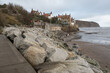 Robin Hood's Bay, Yorkshire, United Kingdom - December 05 2022: A breakwater made of huge boulders located along the coast.