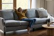 © fizkes - Peaceful relaxed tenant, renter girl enjoying leisure at home, relaxing on soft comfortable sofa at window, breathing fresh air, feeling stress relief, practicing meditating, mindfulness, drowsing