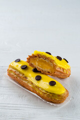 Poster - Beautiful and tasty eclair with yellow glaze and mango-passion fruit flavor