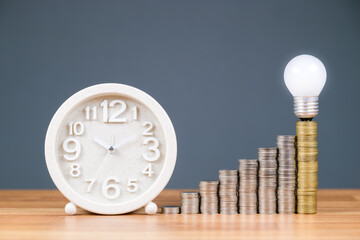 Wall Mural - Time, money, and success : white clock with heap coins stairs and glowing light bulb on the top stage, savings and retirement plan, productivity, or investment concept