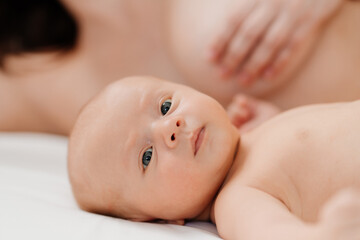 Wall Mural - breastfeeding. the baby lies next to the mother after feeding