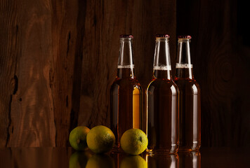 Wall Mural - Beer and lime on the background of a wooden wall