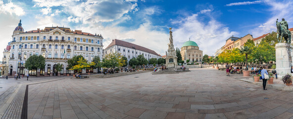 Wall Mural - Panoramic view of Szechenyi square with the former mosque turned roman catholic church , trinity statue and other famous building in downtown Pecs