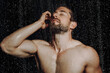 © Shotmedia - man under shower enjoy hot water drops on his nude body while relaxing at morning routine