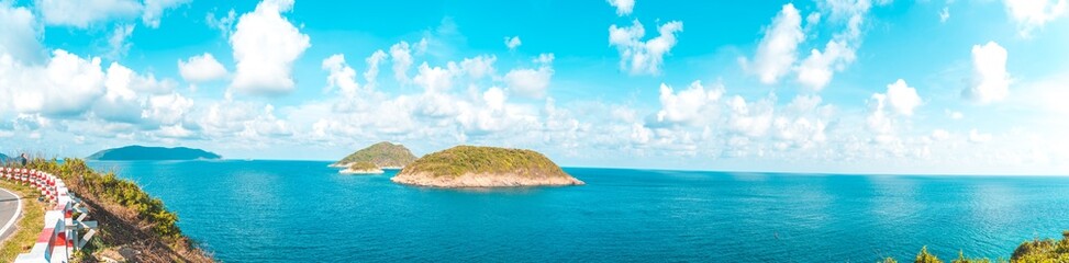 Panoramic coastal Con Dao view from above, with waves, coastline ,clear sky and road, blue sea and mountain.