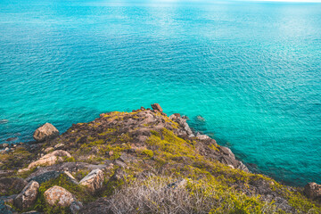 Panoramic coastal Con Dao view from above, with waves, coastline ,clear sky and road, blue sea and mountain.