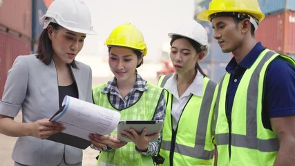 Wall Mural - Logistic Export,Import,transportation concept.Team of Logistic Engineers planning and control loading container box from cargo freight ship,Engineer working on logistic industrial at cargo warehouse