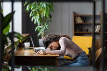 Tired Businesswoman Sleeping On Table In Office. Young Exhausted Girl Lying On Laptop Keyboard, Overwork Unmotivated With Monotonous Tasks Need Rest. Unhappy Freelancer Female Suffer From Burnout
