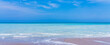 Panorama of a deserted beach. Turquoise clear water and blue sky in sunny weather on the beach in Melbourne, Florida