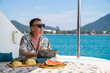 © CandyRetriever  - Caucasian businessman working on digital tablet for online corporate business while catamaran boat sailing on summer vacation. Handsome man enjoy outdoor lifestyle activity tropical travel trip