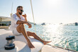 © CandyRetriever  - Caucasian man enjoy outdoor luxury lifestyle with alcoholic drinks while catamaran boat sailing at summer sunset. Handsome male relaxing outdoor leisure activity with tropical travel vacation trip