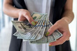 © RomanR - Rich business woman count dollar bills, salary, wage or bribe money