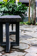 © Papilouz Studio - rough brown hard wood public bench with black metal stands on the city park