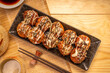 Japanese food Takoyaki octopus balls with takoyaki sauce on wooden table, Traditional Japanese food.