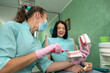 © RomanR - Doctor showing how to clean teeth rightly to a patient