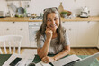 © shurkin_son - Happy senior lady laughing on kitchen. Female on break from classes. Qualified professor giving lecture online from home. Education, study, remote job, technology concept