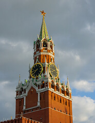 Wall Mural - Huge clock on Spasskaya Tower ofMoscow Kremlin. Red brick against blue sky. Tower is main tower of Moscow Kremlin on Red Square. Ruby star and clock on Spasskaya Tower is historic landmark.