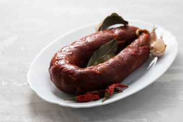 Sticker - typical smoked sausage chourico on white dish