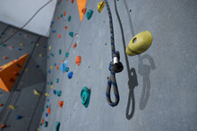Climbing Rope And Wall With Holds In Gym