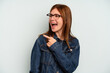 © Asier - Young English woman isolated on blue background looks aside smiling, cheerful and pleasant.