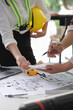 © crizzystudio - Architects, designers, structural engineers, teams, colleagues at work, talking, calculating structures and costs. About the building plan design project, joint plan analysis