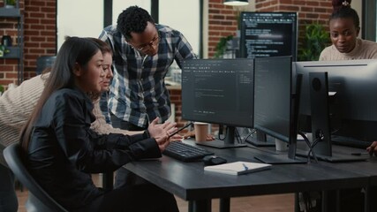 Programmers collaborating on group project compiling algorithm for new cloud computing user interface on computer screens. Mixed team of software engineers brainstorming ideas looking at running code.