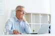 © golubovy - Pensive businessman. Business planning. Work strategy. Network career. Thoughtful senior man looking at laptop in home office workspace.