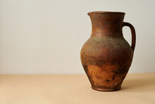 Old Ancient Brown Jug On White And  Peachy Background